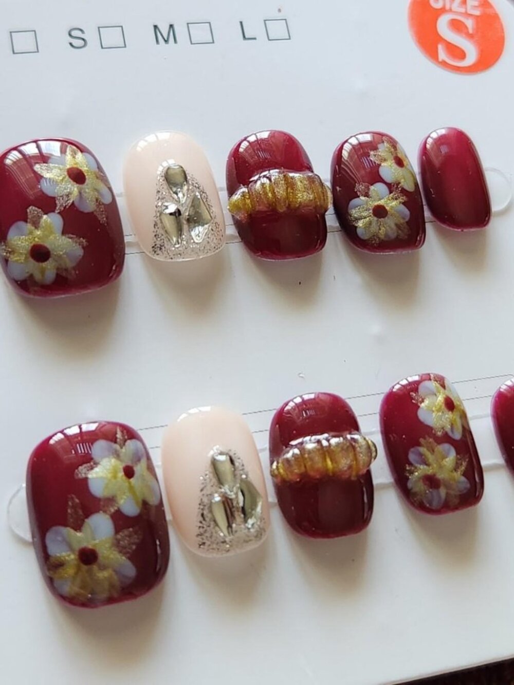 Extra short 1.5 burgundy & pink floral press-on nails with gems.
